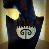 A hand carved double koru breastplate pendant from New Zealand Kokopu Jade. The cord is a black colour and is an adjustable length. A large hand made double Koru shield necklace by New Zealand artist Kerry Thompson.